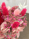 Bouquet of dried flowers with eternal red rose and pink hydrangea stabilized in its small vase, wedding centerpiece