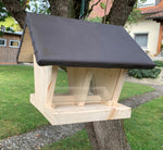 Feeder for garden birds with hinged roof for uncomplicated feeding of the food and weather-protected feeding compartment